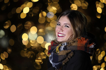 Beautyful girl on the background of Christmas lights