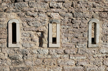 three small windows of a ancient building