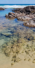  the beach near the rocks in the wave of ocean