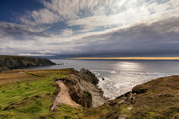 Fototapeta na wymiar Sun and clouds at Irelands coast