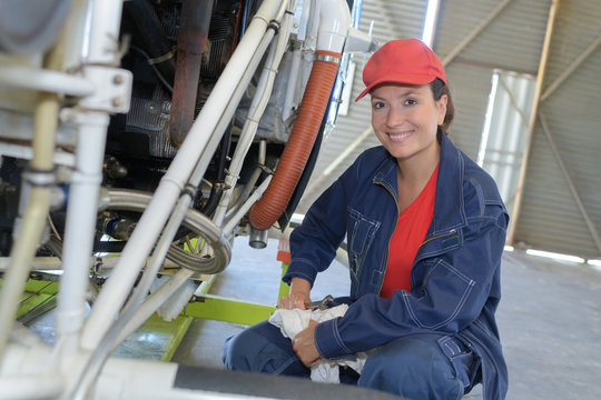 female plumber working on a factory central heating boiler