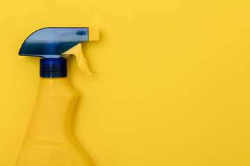 Cleaning spray bottle products on a bright yellow background