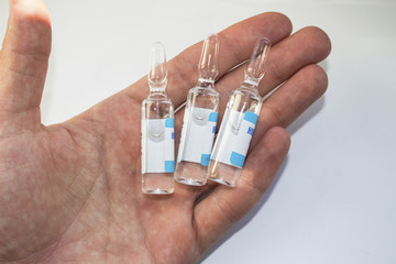 Ampoules with medicine on the palm