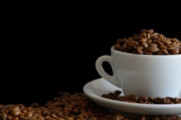 Fresh Roasted Coffee Beans in the White Cup on Black Background