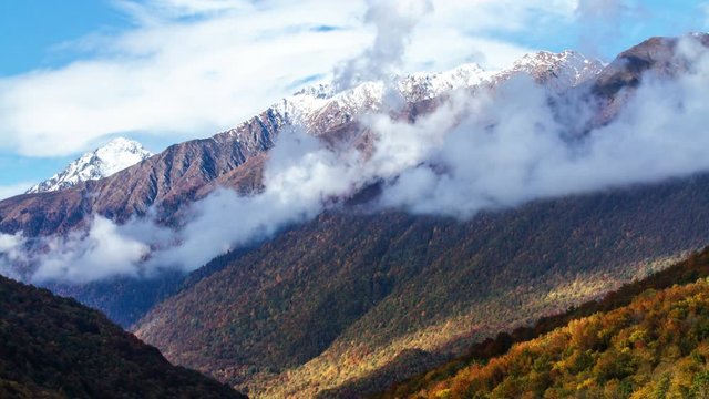 Cloudy mountains landscape with autumn forest at sunset. Time lapse. Sochi, Russia