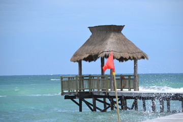 Palapa on Ocean Walkway at Beach with Water Splashing 
