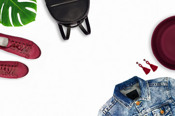 Top view of a backpack, shoes, earrings, hat, jeans jacket. Isolated