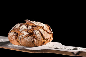 Baking bread in bakery with shovel