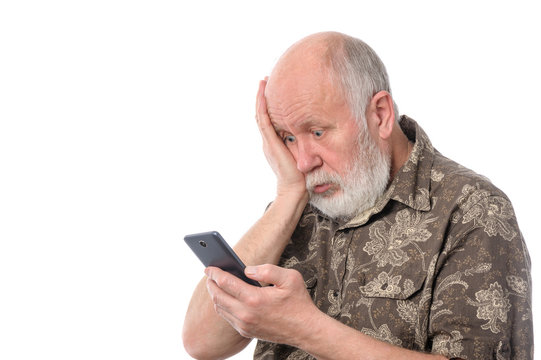 senior man surprized with something at mobile smartphone, isolated on white