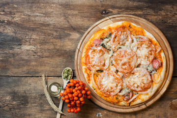 Colorful pizza with mozzarella cheese, chicken, sweet pepper and parsley close up top view. Italian cuisine home cooking. toned image 