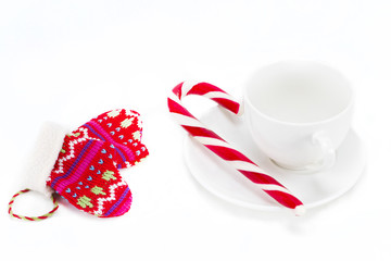 coffee cup with saucer and candy the Christmas cane on white background