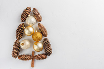 Christmas tree made of cones, decorated with balls on snowy background.  New Year and Christmas conception for postcard with copy space for text