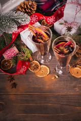 Mulled wine with fruits, cinnamon sticks, anise and decorations