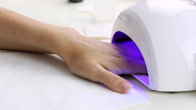 Manicure with led lamp in process