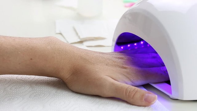Manicure with led lamp in process