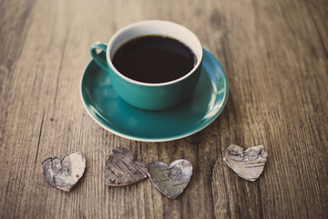 Black coffee and wooden hearts