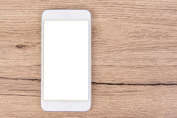 White mobile phone placed on wood desk.