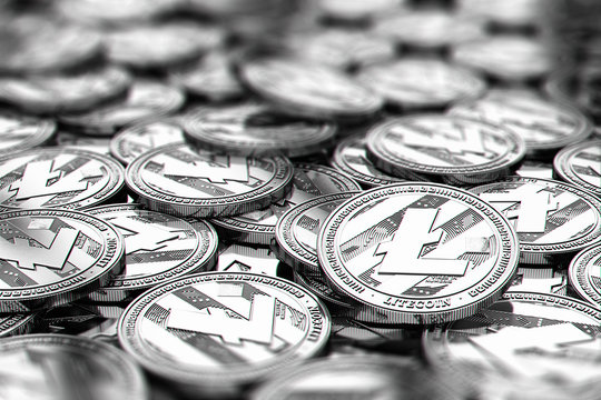 Stack of silver Litecoin coins in blurry closeup with copy space above in blurred area. 3D rendering