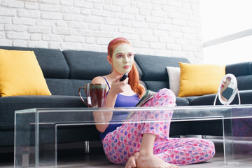 Girl With Beauty Mask Reading And Watching Television At Home