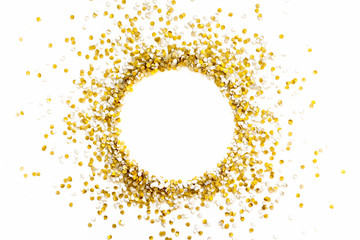 Golden shiny confetti on a white background. Round frame made of confetti. Festive confetti. © kostikovanata