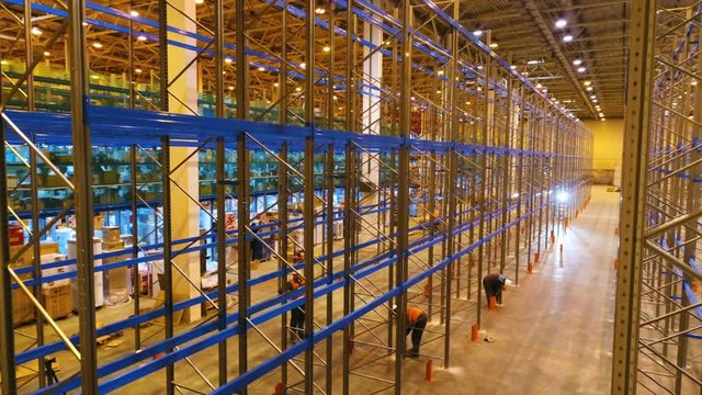 Camera Moves up Rising above Working People Installing Racks