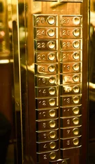 Papier Peint photo Théâtre Gold buttons in the golden elevator.