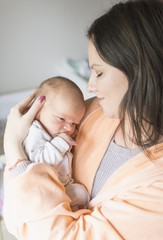 Fototapeta na wymiar woman holding a newborn baby in her arms