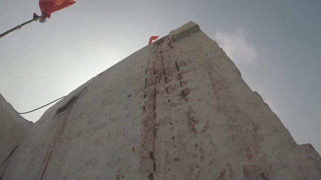 The Hindu god Hanuman's birthplace temple in Hampi, India. CU smooth tracking shot rotating around temple then going to landscape. 2X slow motion.
