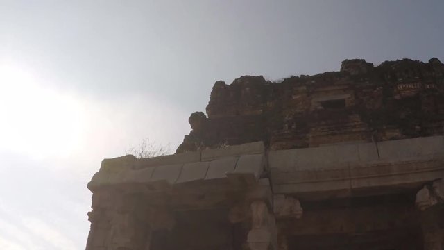 Monkeys climb on the roof of ancient temple ruins in Hampi, India. Still shot. 2X slow motion.