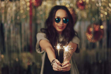  Focus on woman hands holding sparklers