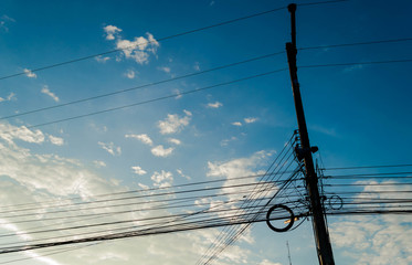 The electric pole and electric transformer with clear blue sky,Power poles in the city center,Electric pole connect to the high voltage electric wires on blue sky background.