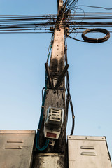 The electric pole and electric transformer with clear blue sky,Power poles in the city center,Electric pole connect to the high voltage electric wires on blue sky background.