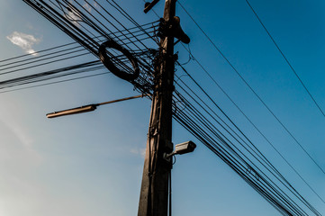The electric pole and electric transformer with clear blue sky,Power poles in the city center,Electric pole connect to the high voltage electric wires on blue sky background.