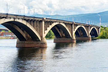 Fototapeta na wymiar Communal bridge across the Yenisei river. Krasnoyarsk, Russia