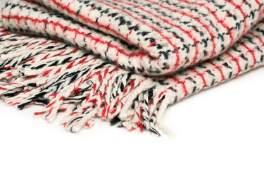 Checkered woolen .plaid with tassels isolated on white background, close-up
