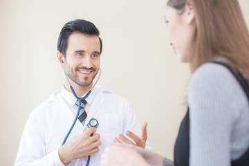 Doctor using stethoscope with attractive smiling. People with medical concept.