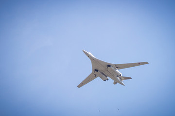 Fototapeta na wymiar bomber flies in the blue sky