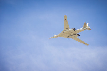 Fototapeta na wymiar bomber flies in the blue sky