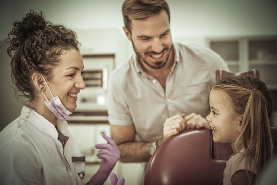 Father and little girl in dentist office.