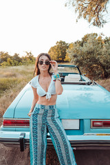 Girl posing on a background cabriolet