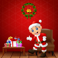 Happy kid presenting in the living room with christmas and new year decoration