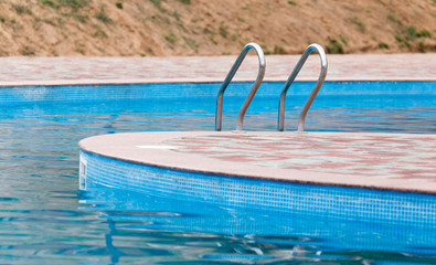 Ladder in the pool in the nature