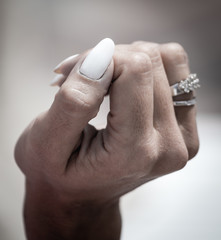 A woman's hand with a manicure and a ring on her finger