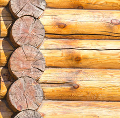 Wall of a house with a log frame as a background