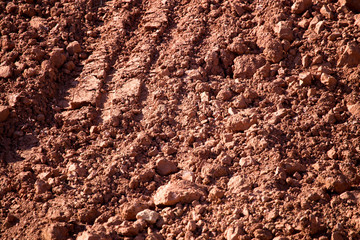 Red clay soil on nature as a background