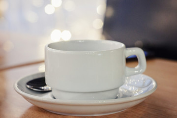 Obraz na płótnie Canvas white Cup on table in cafe