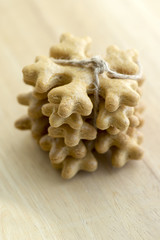 Traditional tasty Czech gingerbreads tied with jute rope, Christmas snowflakes on wooden table