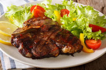 T-bone beef steak with fresh vegetable salad closeup. horizontal