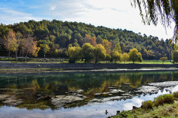 Beautiful countryside view by river framed whit trees
