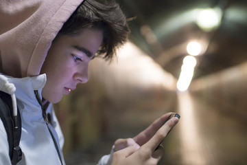 teenage student talking on mobile phone in town